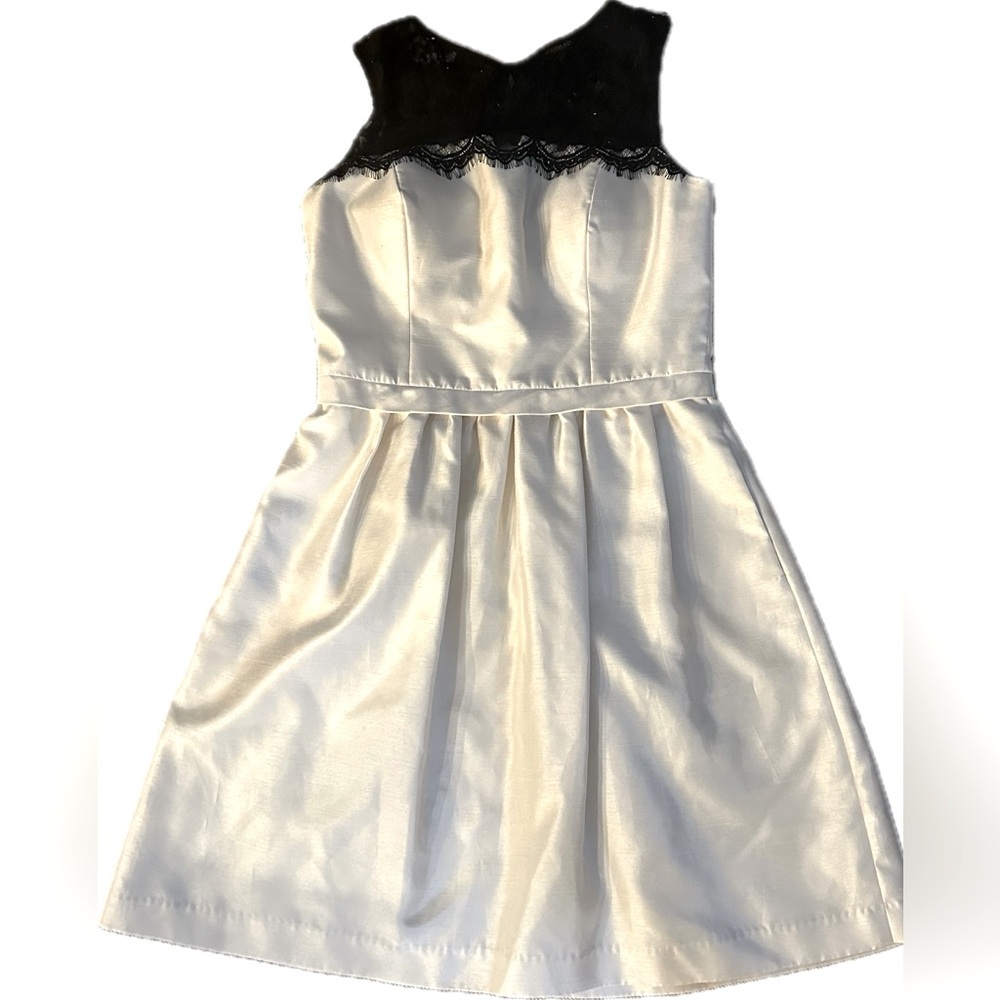 White cocktail dress with black lace detail shoulders. Size 6.